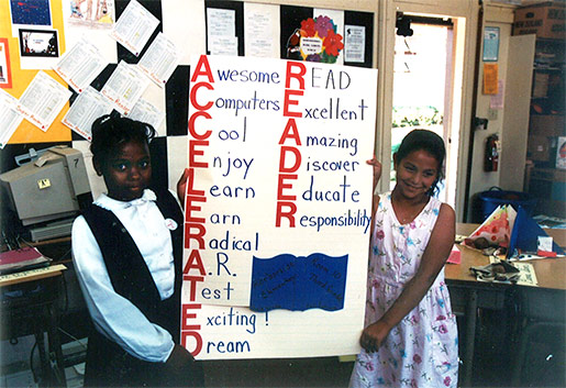 Photo of girls holding a poster about Accelerated Reader
