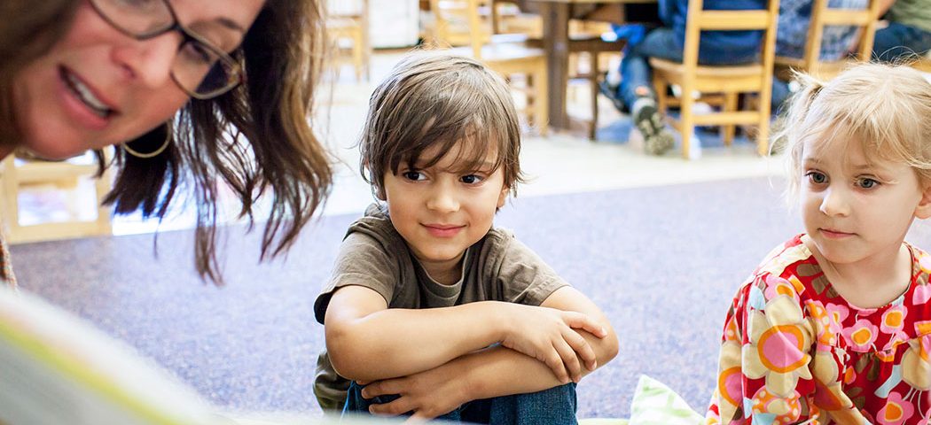 Photo of children sitting on the floor