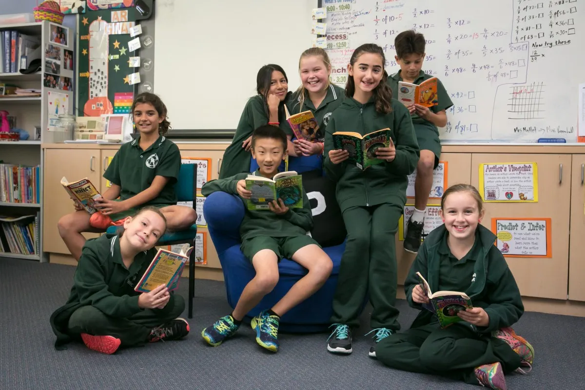 Teacher at Ashfield Primary next to books